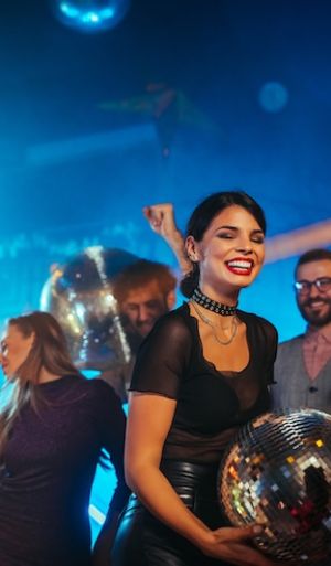 Group of friends partying in a club and moving to the music.